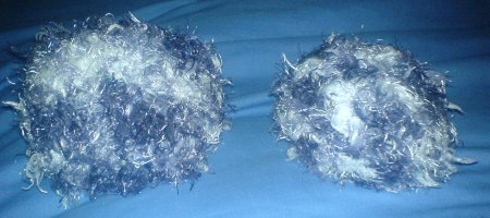 Two grey and white fuzzy knitted toy tribbles